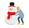 Stylishly dressed man or old man with a beard in a long jacket with a hood makes a snowman wearing a red scarf. Fun