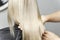 stylist calorist shows model`s dyed blond hair.