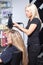 Stylist drying woman hair