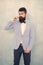 Stylist fashion expert. Suit style. Fashion trends for groom. Groom bearded hipster man wear light blue tuxedo and bow