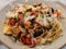 Stylist food,Close up homemade Italian pasta spaghetti salmon garlic mushroom top with chop parsley in restaurant.healthy food.Ita