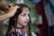Stylist hairdresser makes a hairstyle for a cute little girl in a beauty salon. Hairdressing, hair cutting