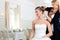 Stylist pinning up a bride\'s hairstyle