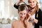Stylist pinning up a bride\'s hairstyle