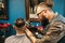 Stylist shaving male head at barber shop