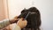 Stylist straightens a strand of hair