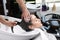 Stylist washing client`s hair at sink