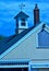 Stylized blues and yellow barn image with cupola and weathervane