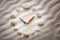 Stylized dial clock pebble and shells arrows on the sand for concentration and relaxation for harmony and balance