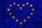 Stylized European Union flag, symbol of united Europe on soft silk with soft folds, close-up