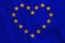 Stylized European Union flag, symbol of united Europe on soft silk with soft folds, close-up