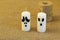 Stylized ghosts made of white wax candles and coil of jute cord on rough canvas. Minimal style. Symbolic concept for Halloween, ce