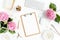 Stylized women`s desk. Workspace with clipboard, computer, bouquet hydrangea, accessories on white background. Flat lay