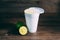 A styrofoam cup and a citrus fruit