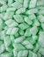 Styrofoam packaging chips or peanuts, green packing material background texture