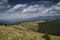 Subalpine meadow and a road on a slope of a mountain in the Carpathian mountains