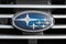 Subaru emblem on a radiator grill. Silver stars on a blue background