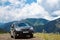 Subaru Forester car stand on a dirt road in the green mountains