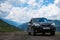 Subaru Forester car stand on a dirt road in the green mountains