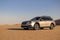 Subaru Outback standing in the middle of the Namib desert.