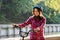 Subject ecological mode of transport bicycle. Beautiful young kasazy woman wearing a blue helmet and long hair poses standing next