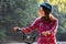 Subject ecological mode of transport bicycle. Beautiful young kasazy woman wearing a blue helmet and long hair poses standing next