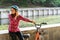 Subject ecological mode of transport bicycle. Beautiful young kasazy woman wearing a blue helmet and long hair poses standing next