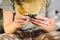 Subject medicine health and pharmaceuticals. Close-up macro young caucasian woman hands pulling out a green blister. Packing two