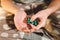 Subject medicine health and pharmaceuticals. Close-up macro young caucasian woman hands pulling out a green blister. Packing two