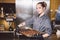 Subject profession and cooking pastry. young Caucasian woman with tattoo of pastry chef in kitchen of restaurant preparing round