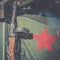 Submachine gun of Shpagin, PPSh is leaning against the armor of a tank. The red star, as emblem of the Soviet Army, drawn on the t