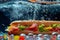 Submarine sandwich submerged in water with bubbles around