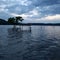 Submerged benches and tree in an artificial lake that has flooded the coast