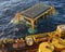 Submersible equipment and structures are lowered to the seabed in Bass Strait Australia from a work boat.
