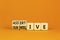 Submissive or assertive symbol. Concept words Submissive and assertive on wooden cubes. Beautiful orange background. Business,