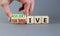 Submissive or assertive symbol. Concept words Submissive and assertive on wooden cubes. Businessman hand. Beautiful grey