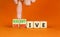 Submissive or assertive symbol. Concept words Submissive and assertive on wooden cubes. Businessman hand. Beautiful orange