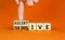 Submissive or assertive symbol. Concept words Submissive and assertive on wooden cubes. Businessman hand. Beautiful orange