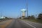 Suburban America, Texas, United States. Perspective landscape view of a road, highway with water tower and power poles.