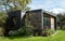 Suburban garden in Pinner, Middlesex UK with contemoorary garden studio with black and cedar cladding and green roof.