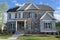 Suburban home with grey siding and stone exterior