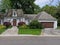 Suburban house with cedar shingle roof and dormer window