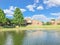 Suburban lakefront houses with water fountain and green grass lawn near Dallas