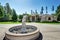 Suburban luxury house with fountain statue in the front yard