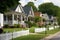 suburban neighborhood with front porches, picket fences, and rolling lawns