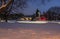 Suburban Neighborhood Houses Lit Up with Christmas Lights and Covered with Snow