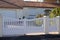 Suburban pvc plastic gate white fence on home suburb street access house garden