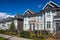 Suburban residential street townhomes. On bright sunny spring day against bright blue sky.