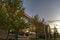 Suburban townhouse facade with trees near sunset