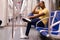 Subway passenger male in yellow shirt posing in subway car